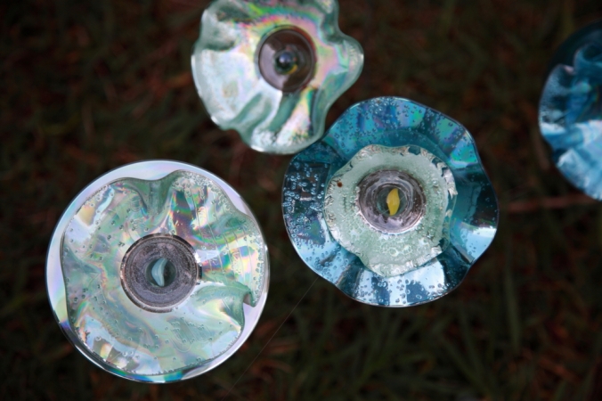 Old CDs and DVDs are upcycled into flowers, which are dotted around the garden